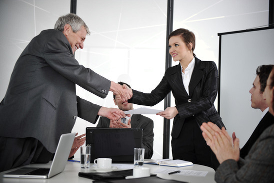 Happy Business Leaders Handshaking At Meeting